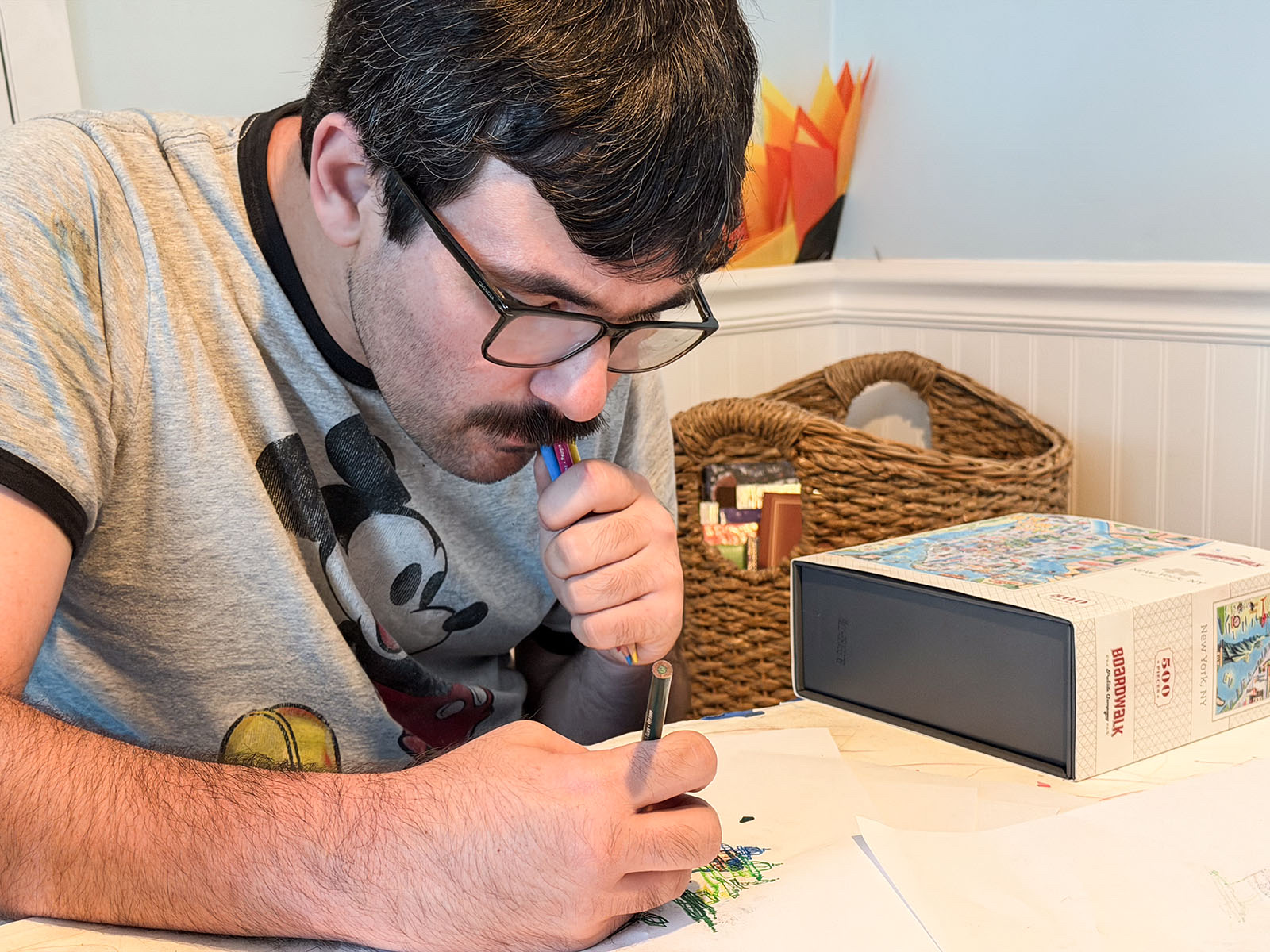 Matthew drawing at a table with colorful art supplies